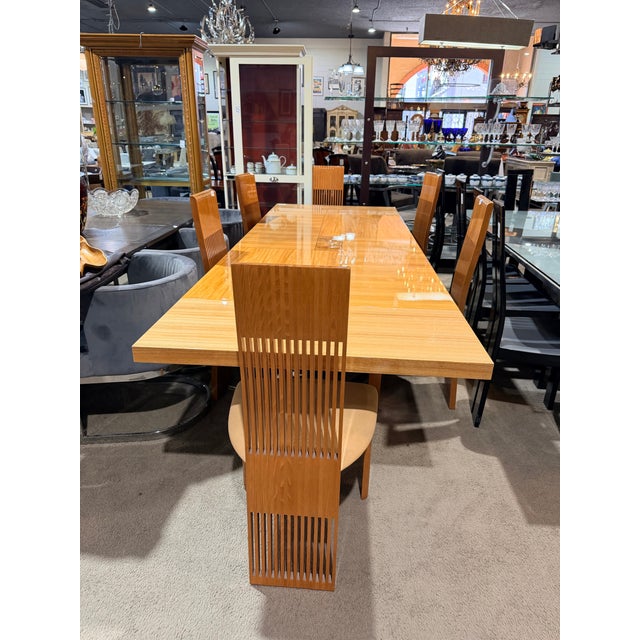 A striking zebrawood dining table by Pietro Constantini, featuring a rich tan finish and bold natural grain patterns....