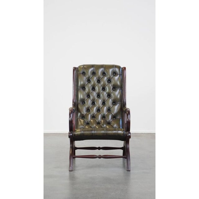 This nice green cowhide chesterfield armchair with an elegant design and combined with wood. This great armchair in a...