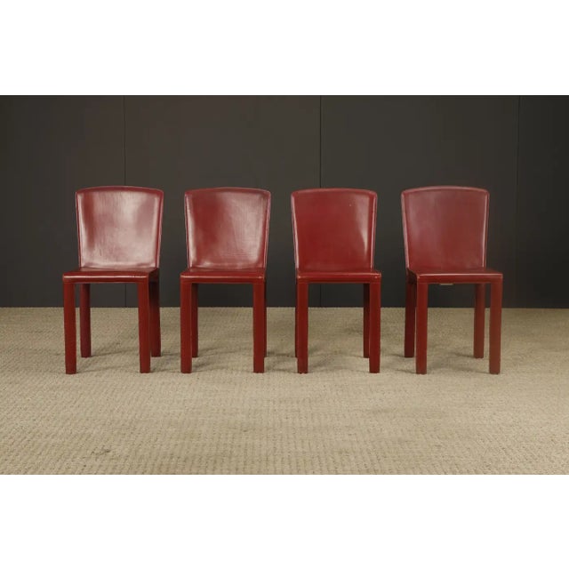 A handsome and well-crafted set of four dining chairs by Zanotta, Italy circa 1980s, in rich burgundy leather. Often...