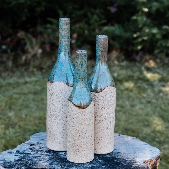 Decorative bottle vase, wheel-thrown from speckled stoneware and coated with "Satin Clear" inside and "Arctic Blue" glaze...