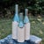 Decorative bottle vase, wheel-thrown from speckled stoneware and coated with "Satin Clear" inside and "Arctic Blue" glaze...