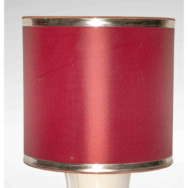 Vintage bamboo lamp is an original design lamp realized in the 1970s. A vintage lamp in ceramic and brass with a red...