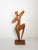 Elegant abstract wooden sculpture depicting a stylized female figure in a graceful dancing pose. Hand-carved from solid...