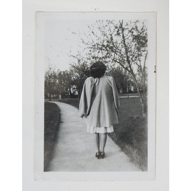 1950's vernacular snapshot photograph of a woman in her stylish best with her back turned to the camera. Unframed, small...