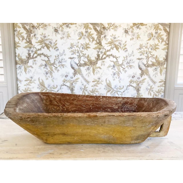 This large wooden trencher was hand-made in the 19th Century. It has a beautifully aged surface. We love the yellow paint...