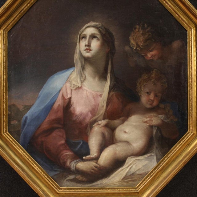 A refined 18th-century Italian painting. This artwork oil on canvas depicts a splendid Madonna and Child with a cherub,...