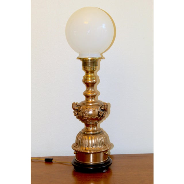 Add dramatic vintage elegance to your space with this striking Asian-inspired brass table lamp featuring an ornate figural...
