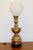 Add dramatic vintage elegance to your space with this striking Asian-inspired brass table lamp featuring an ornate figural...