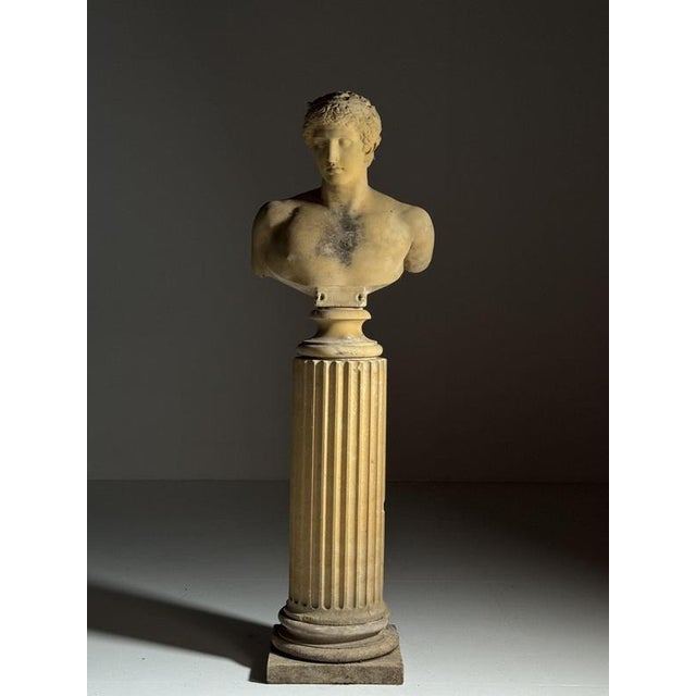 Life-size bust of antinous on column, 20th century. Monumental, life-size bust of antinous, executed in cast stone and...