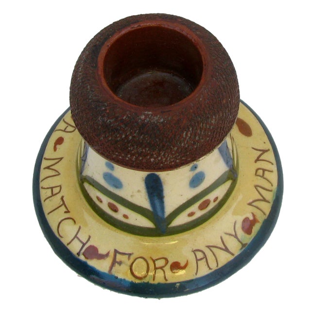 This charming match strike is lovely example of English Torquay red earthenware pottery. A wonderful addition to a match...