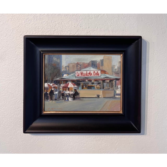 This oil painting captures a lively scene at a market cafe, where patrons gather under colorful umbrellas, enjoying the...