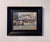 This oil painting captures a lively scene at a market cafe, where patrons gather under colorful umbrellas, enjoying the...
