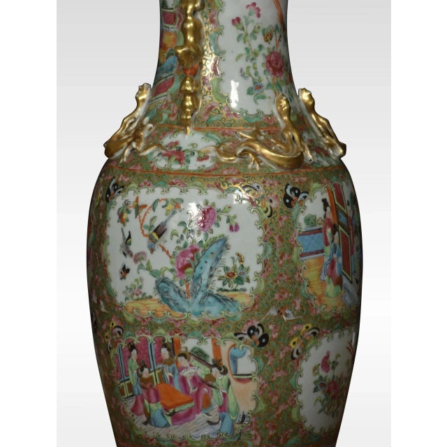 Cantonese twin-handled baluster vases lamp, decorated in the famille rose palette with cartouche panels of figures, exotic...