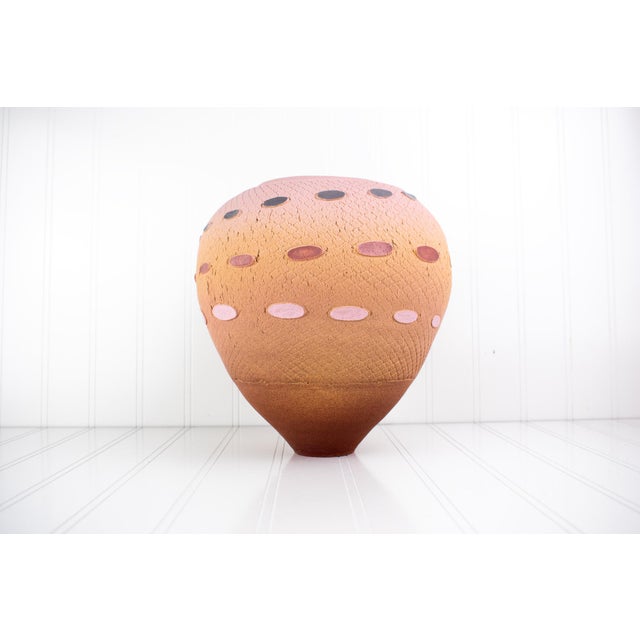 A large, hand-thrown studio art pottery vase by American ceramicist Jamie Fine. This earthenware vessel features an ovoid...