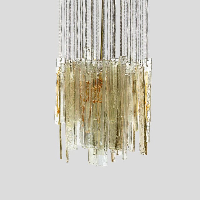 An Italian design ceiling light, blown glass components on a steel chain links, brass metal structure, 1970’s. Up to 250V...