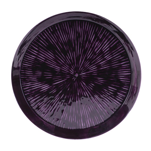 Add a bold splash of color and elegance to your space with this round etched metal tray. Featuring cool plum purple tones...