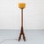 Dutch Amsterdam School floor lamp dating from circa 1925, crafted in oak with dark-stained wooden details. The tall,...