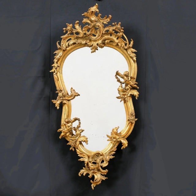 Large wall mirror in Rococo style. Carved wood, gilding. Measure and harmony define it. Neither the diagonal of the...