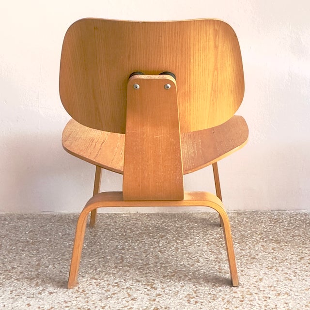 This is the Eames Molded Plywood Lounge Chair with Wood Base (LCW), designed by the legendary husband-and-wife duo Charles...
