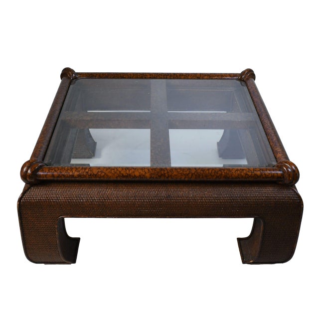 Anchor your living room with this striking Ming-style coffee table. The square base is intricately woven from rattan in a...