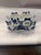 Charming hand-painted Delft Blue ceramic napkin holder featuring a cheerful cow couple dressed in classic Dutch farm...