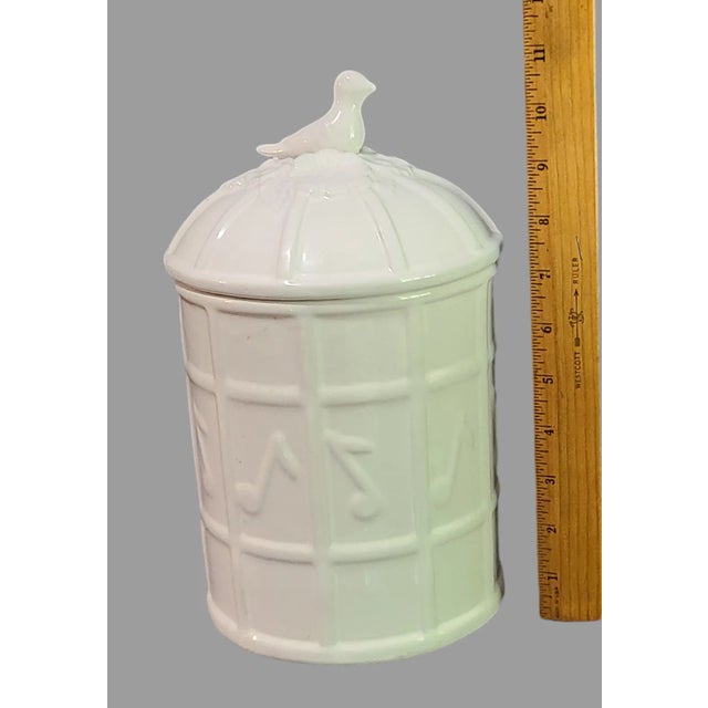This vintage cookie jar is a unique addition to any kitchen or collection. The white porcelain jar features a music notes,...