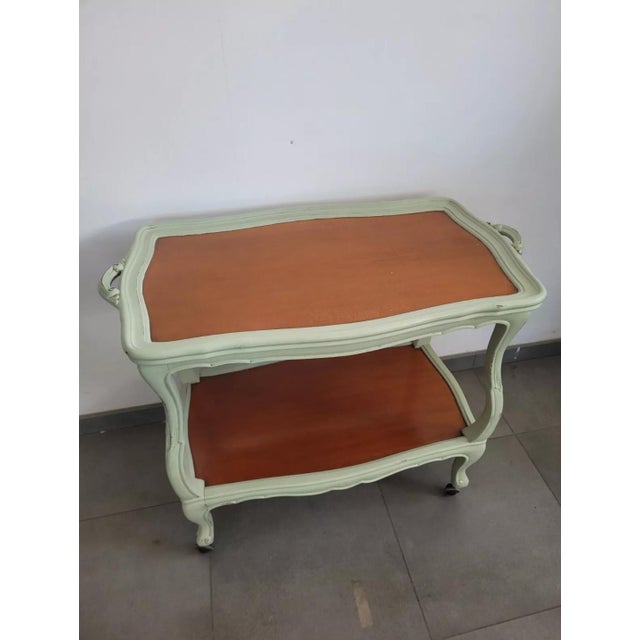 Bar trolley with double shelf for objects. The object is equipped with wheels that allow easier movement. On the side...