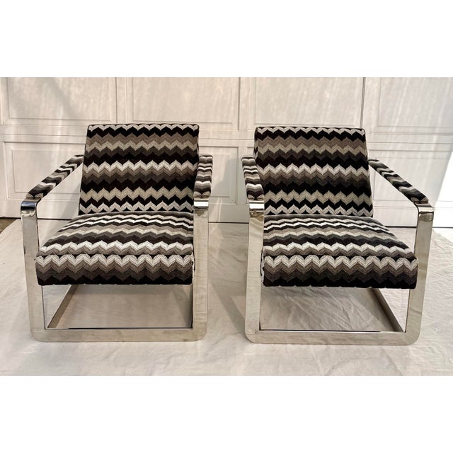 Here is a fabulous pair of mid-20th century lounge chairs featuring sculptural angular chrome frames with front and rear...