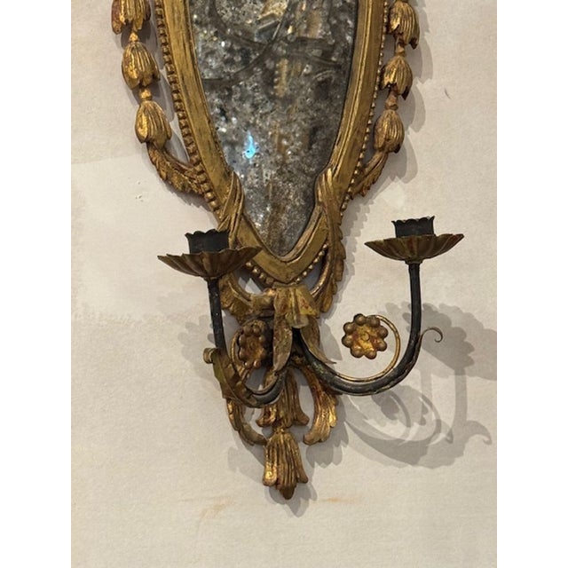 The product is a pair of 19th century Italian giltwood sconces. These sconces are likely to be ornate and elegant,...