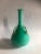 Vase glass jacketed green / turquoise, with 4 loops in green transparent glass and applied gold leaf. H 32.5 cm diameter...