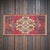 This striking vintage Anatolian mat instantly captivates with its bold, geometric tribal patterns and vibrant crimson...