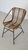 Woven rattan lounge chair, Italian design. Fits perfectly into a minimalist 1960s lounge setting. Matte black metal base.