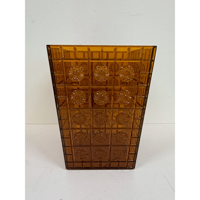 Vintage amber plastic waste basket with molded geometric pattern and raised medallion design. Tapered rectangular form...