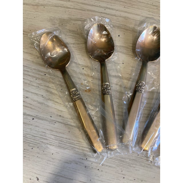 A nice set of 6 bronze small spoons. These were never used and are still in the packaging. Labeled j.s.h. on the back.