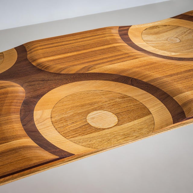 Bench crafted from a combination of woods, including maple, beech, cherry, and walnut. The eponymous ripple effect flows...