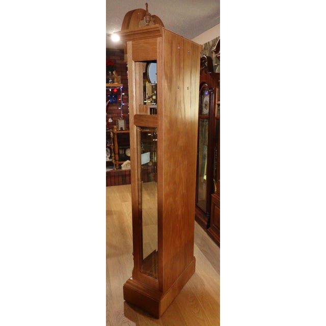 Elegant and exceptionally preserved, this Hermle North America grandfather clock presents in true new old stock condition...