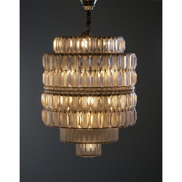 This tiered crystal chandelier was produced in the 1960s by Lustry Kamenický Šenov, a leading Czechoslovak manufacturer...