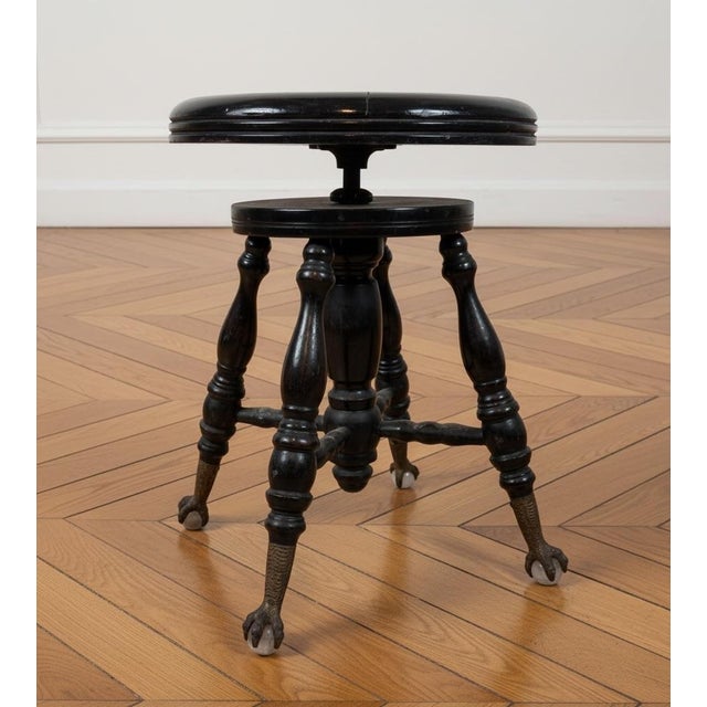 Exquisite antique Victorian piano stool featuring an adjustable seat. The claw and ball feet adorned with glass ball...