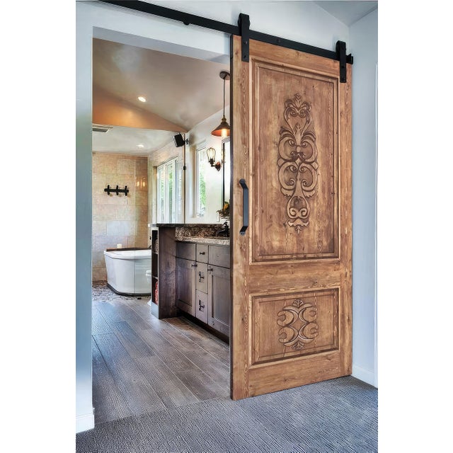 This handcrafted solid wood interior door showcases a refined Mediterranean–Tuscan influence, featuring deep ornamental...
