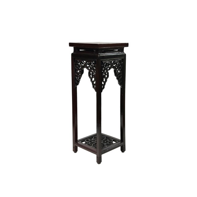 This elegant, oriental-inspired display stand is crafted from a deep, dark brown wood that features a rich, polished...