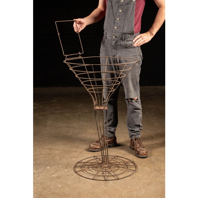 Figural wire-craft store display. This piece takes the form of a martini glass. Though we're unsure, it likely once held a...