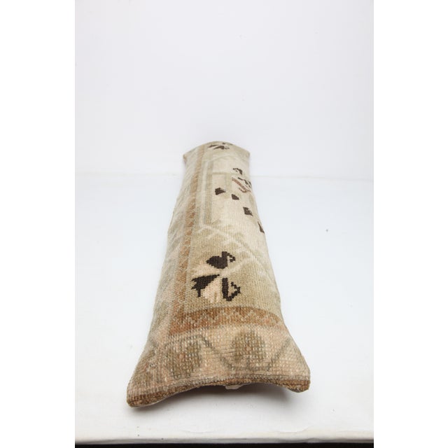 This handcrafted lumbar pillow cover is made from a vintage tribal Turkish Rug, showcasing a beautifully aged patina and...