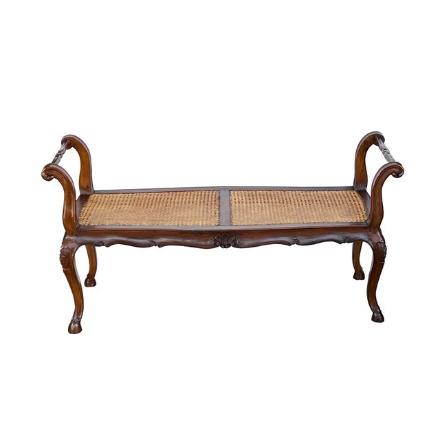 the shapely hand-carved bench of pegged construction with serpentine caned seat flanked by upright outscrolled arms; all...