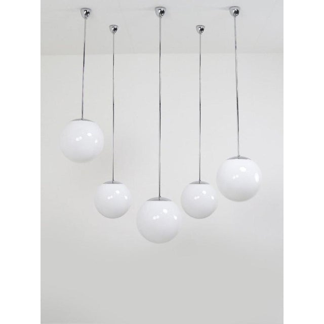 This beautiful batch of vintage glass tecnolumen hanging lamps is special because of its simplicity. Also called 'globe'...
