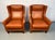 A striking pair of mid-century modern brown leather lounge chairs crafted by Wiels Møbler in Denmark. These chairs feature...
