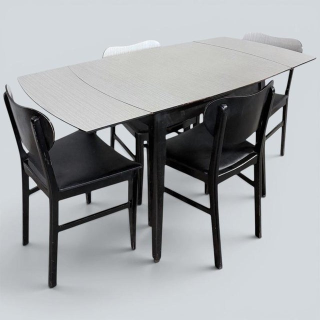Mid Century Space Age Monochrome Formica Drop Leaf Extending Dining Table & Four Chairs A striking mid-century dining set...