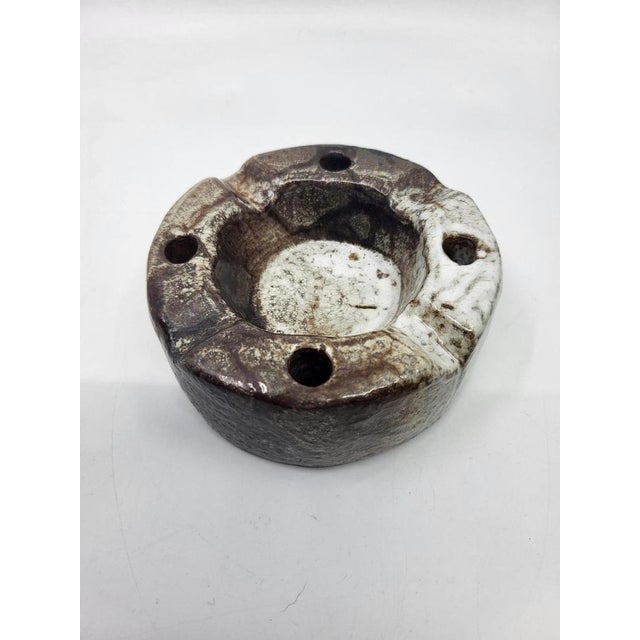 This 1950s ashtray or trinket tray embodies the unique, brutalist spirit of Alsatian pottery, crafted from glazed...