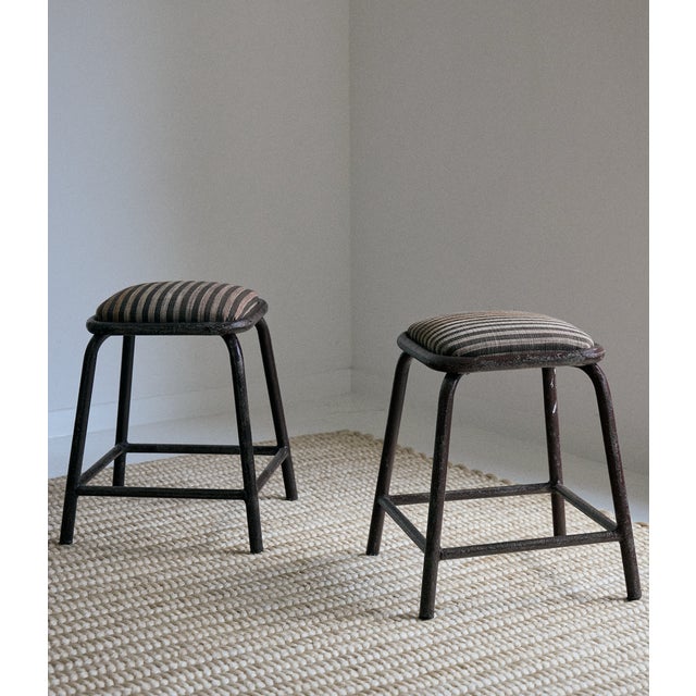 Pair of industrial metal stools from Portugal. These stools have been newly reupholstered in a Zak + Fox indoor/outdoor...