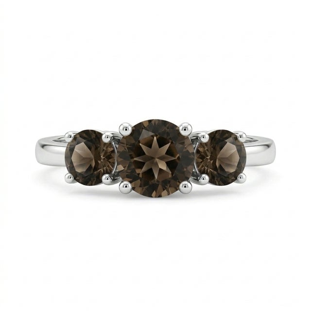 This captivating ring showcases three round-cut smoky quartz gemstones, each exuding a rich, warm brown hue with subtle...