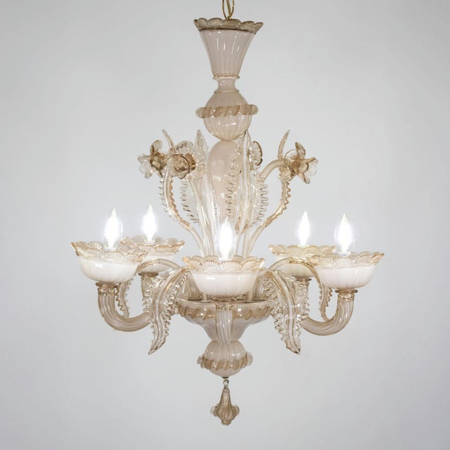This exquisite milk and honey-colored Murano glass chandelier showcases a mastery of Venetian glass craftsmanship....